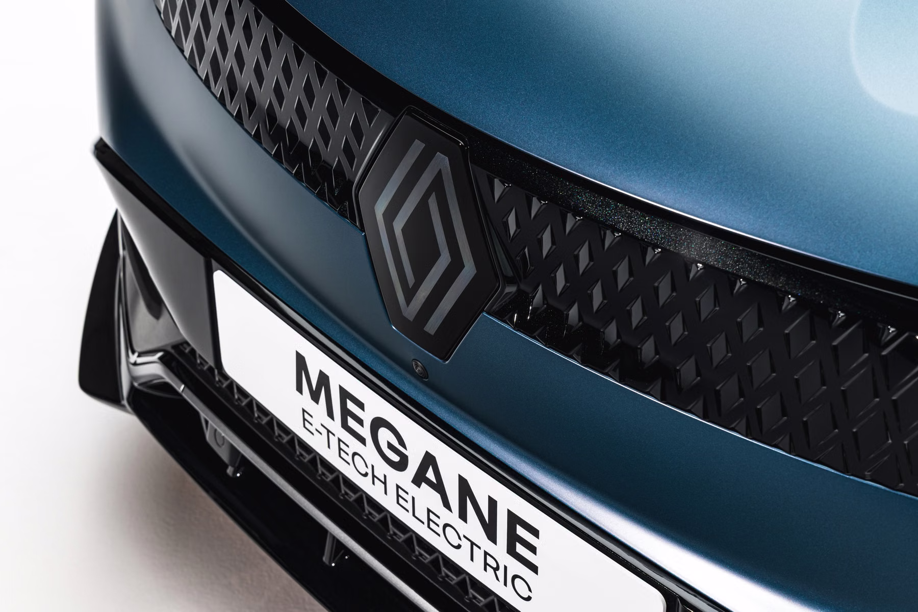 Detalhe da frente do Renault Megane E-Tech Electric com logotipo e grade fechada