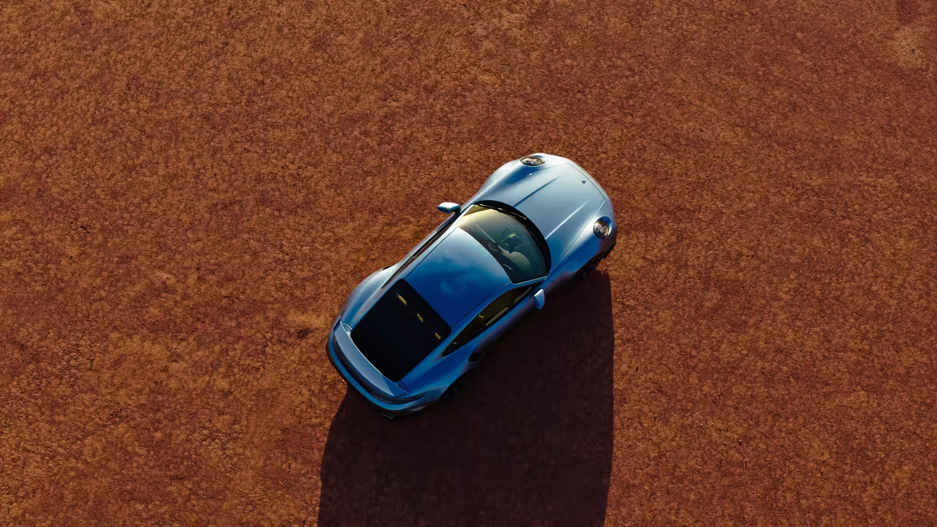 Porsche 911 Turbo S Land Down Under visto do alto sobre terra vermelha