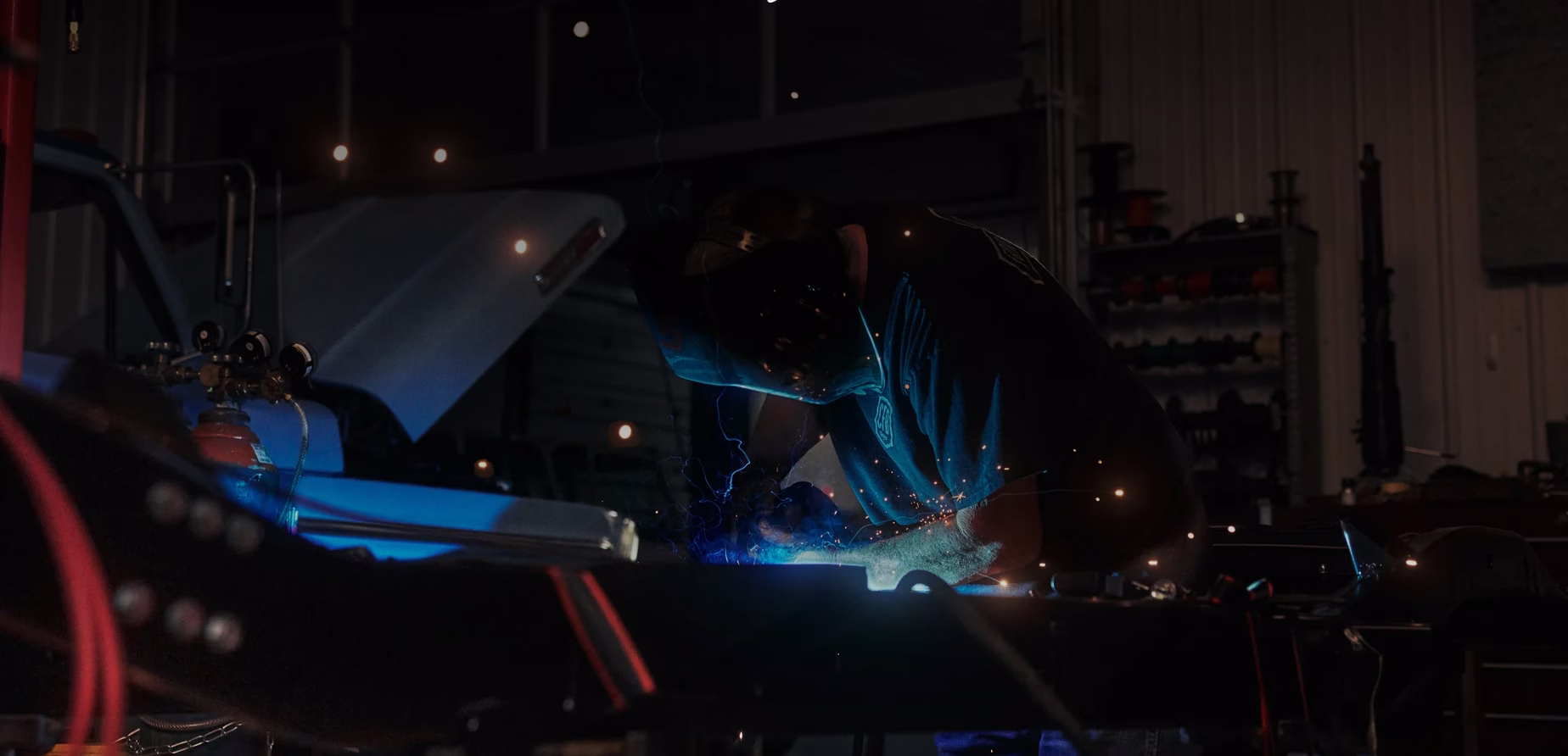 Profissional executando solda em uma estrutura na oficina da Classic Ford Broncos
