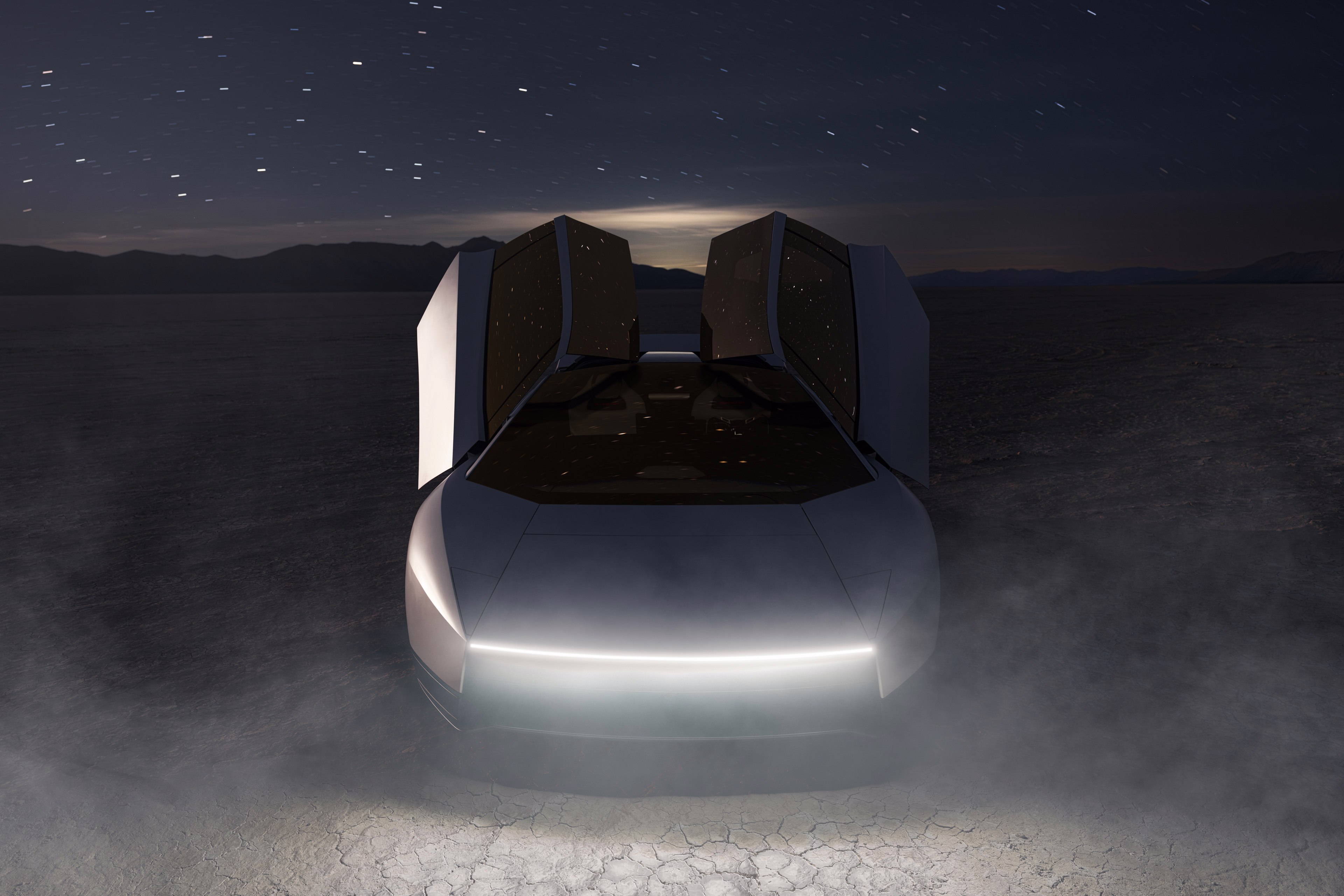 Roadster visto de frente com portas elevadas e iluminação branca à noite